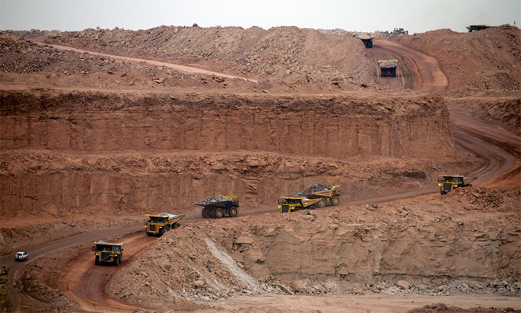 Heavy vehicles move on a road to a mining site in Niger.