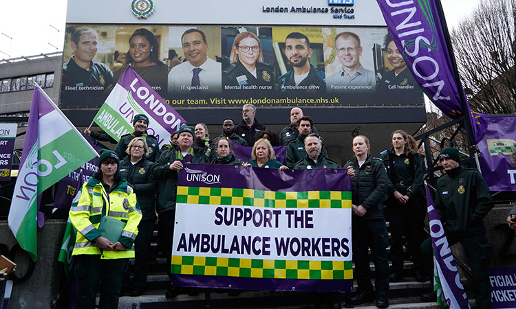 Christina McAnea, general secretary of UNISON, poses with ambulance workers at a picket line outside the Waterloo ambulance station in London on Dec.21, 2022. AFP
