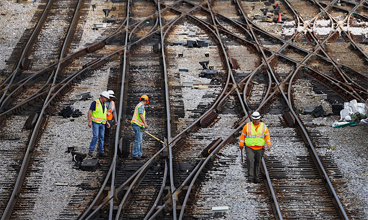 Railroad workers carry out routine inspections of tracks in a Los Angeles area.