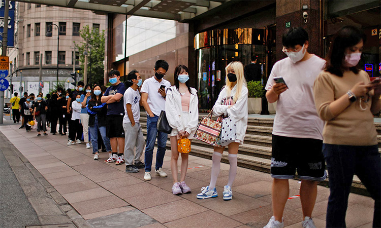 People line up to get tested for COVID-19 at a testing site in Shanghai. Reuters