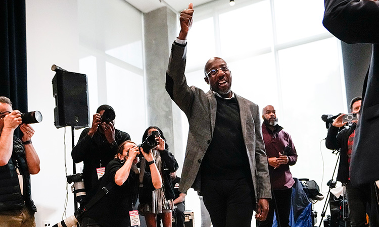 US Sen. Raphael Warnock, waves to supporters as arrives to speak at a campaign rally at Georgia Tech, in Atlanta on Monday. Associated Press