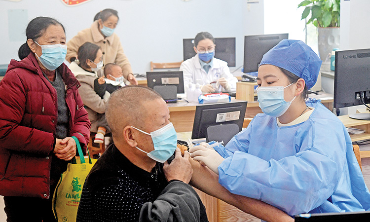 A medical worker administers a dose of the COVID-19 vaccine to an elderly resident at a community health service centre in Jinhua, Zhejiang province, China.  Reuters