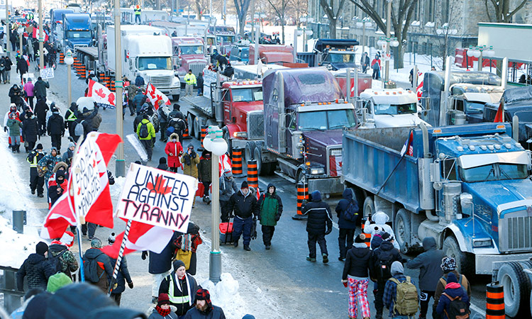 Trucks sit parked on Wellington Street near the Parliament Buildings to protest COVID-19 vaccine mandates for cross-border truck drivers in Ottawa, Ontario, Canada.   Reuters