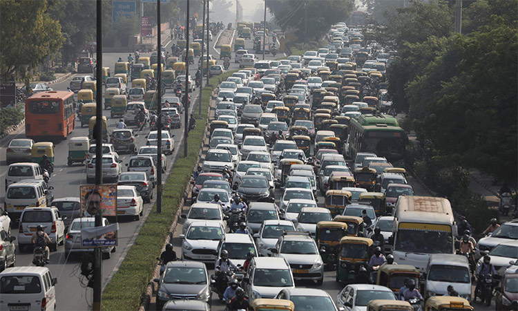 Vehicles queue at a traffic light on a hazy morning in New Delhi, India. Reuters