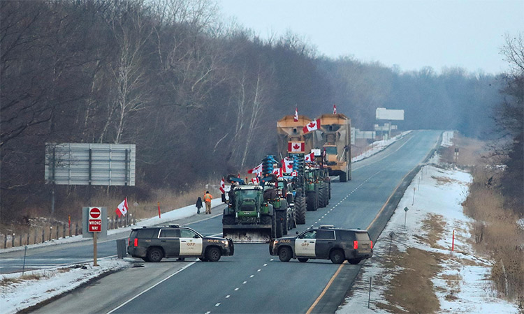 Vehicles block highway 402, about 30 kilometers east of Sarnia's Blue Water Bridge border crossing in Canada.