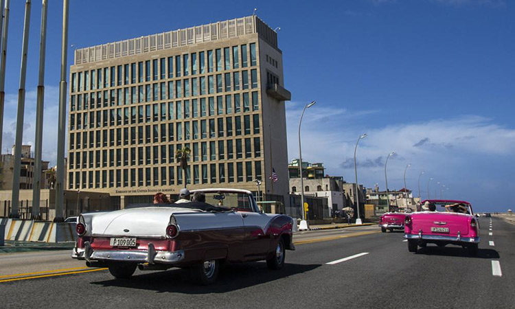 Tourists ride classic convertible cars on the Malecon beside the United States Embassy in Havana, Cuba. File/AP