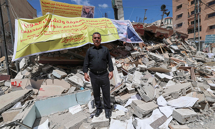 Samir Mansour, Palestinian owner of the eponymous bookstore and publishing house that had the largest collection of English literature in Gaza, stands in front of the rubble of his bookshop after it was destroyed by Israeli airstrikes, Gaza City. AFP