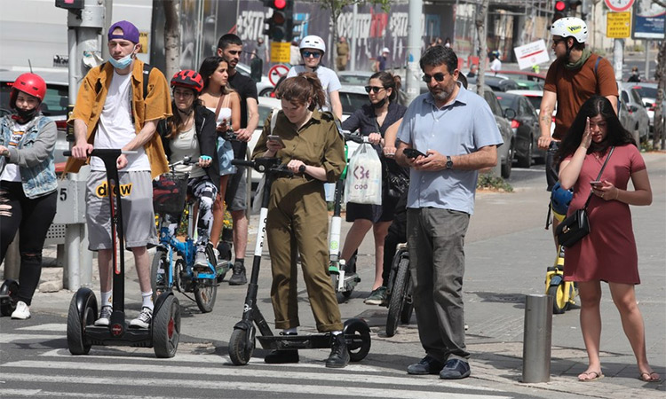 People without face masks are seen outdoors in Tel Aviv, Israel. (Image via Twitter)