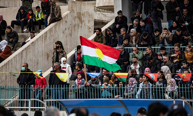 Syrian Kurds gather in the Baladi Stadium to commemorate the bloody clashes between members of their community and Syrian regime forces in 2004, Syria’s northeastern Hasakeh province, on Saturday.  AFP