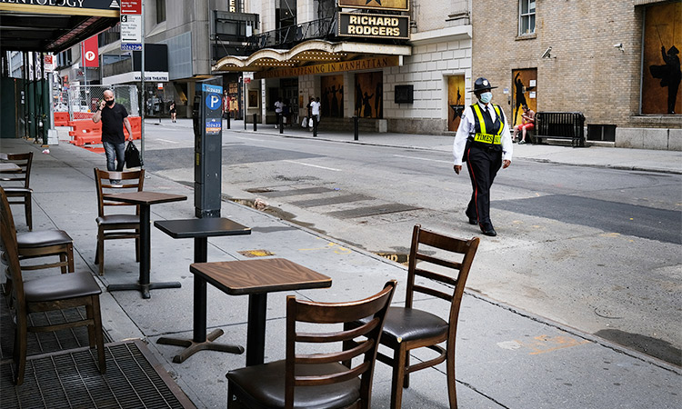 Broadway theatres stand closed along an empty street in the theatre district in New York City. Tribune News Service