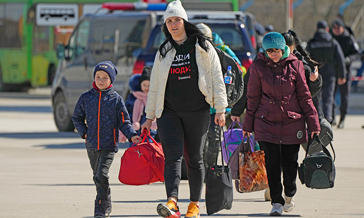 Women with children fleeing the war from neighbouring Ukraine arrive at the border crossing in Palanca, Moldova. AP
