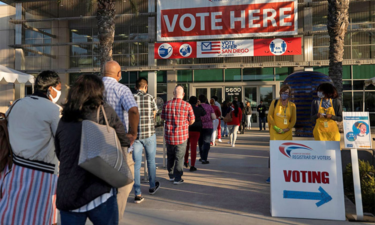 People queue up early to cast their votes at a polling station in San Diego. File/Reuters