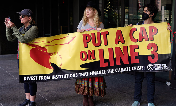 Members of the Youth Climate Los Angeles coalition and others protest the Line 3 pipeline and the climate crisis outside City National Bank in Los Angeles, on Friday. AP