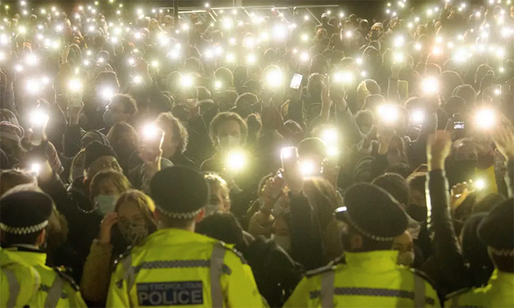 Cellphones' torches glow during a vigil in London.
