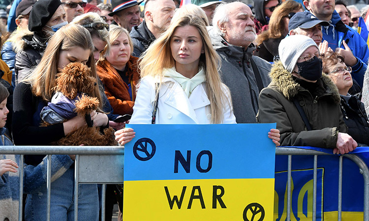 A woman holds a sign with a message of support for Ukraine, following Russia’s invasion of the country, during a protest in Zagreb’s main city square.  AFP