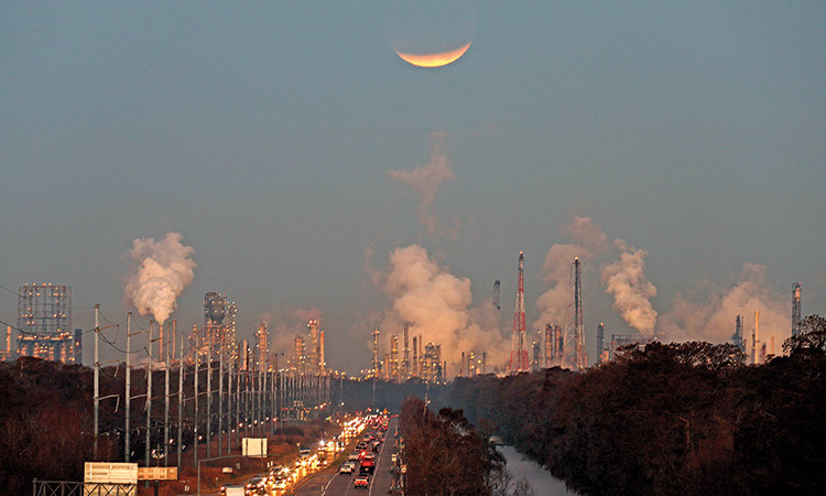 A supermoon undergoes a partial eclipse as it sets beyond the Shell Norco Manufaturing Complex, at sunrise in St. Charles Parish, Louisiana.  File/Associated Press