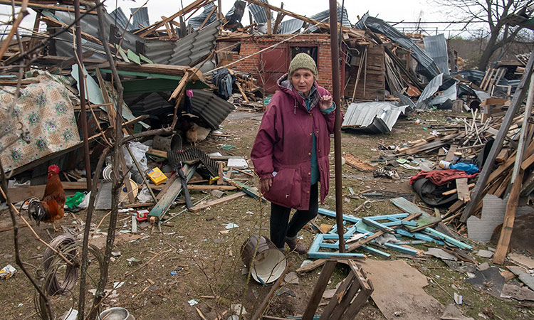 Local resident Liubov stands next to her house destroyed during Russia’s invasion in the village of Kukhari, in Kyiv region, Ukraine on Sunday. Reuters