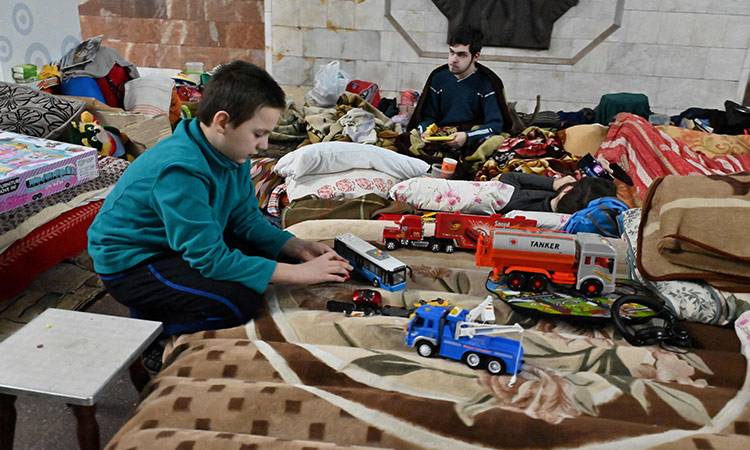 A child plays as he shelters with others in a subway station on the northern outskirts of the second largest Ukrainian city of Kharkiv amid the Russian invasion of Ukraine.    Agence France-Presse