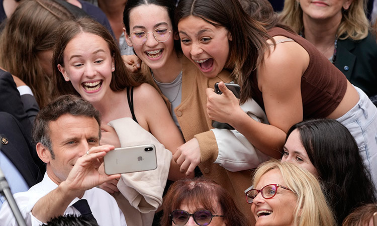 Emmanuel Macron makes a selfie with his supporters in Figeac, southwestern France. File/AP