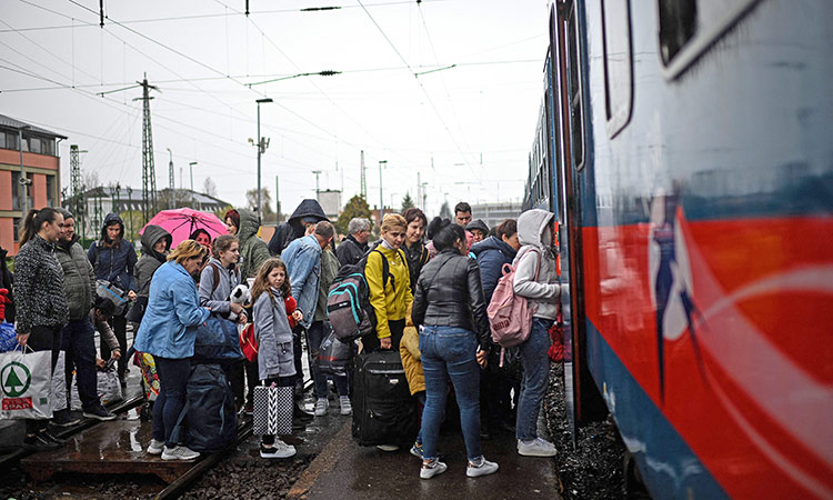 Ukrainian refugees board a train taking them back into Ukraine at the Zahony train station along the Ukrainian-Hungarian border, eastern Hungary.  AFP