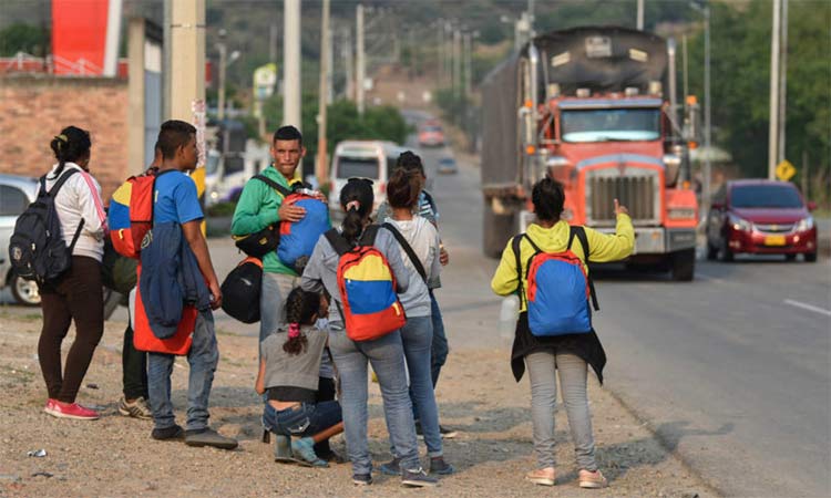 Venezuelan migrants walking through Colombia try to hitch a ride. 
