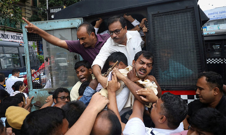 Demonstrators shout slogans from a police vehicle after being detained during a protest against "Agnipath" scheme for recruiting personnel in the armed forces, in Kolkata, India. Reuters