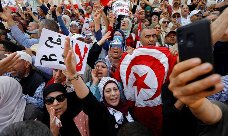Demonstrators carry banners and flags during a protest against Tunisian President Kais Saied in Tunis, Tunisia. Reuters