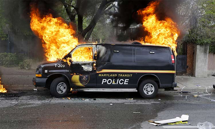 A police vehicle burns during a protest in Baltimore. File/AP