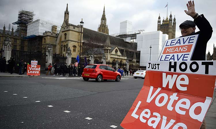 A pro-Brexit protester holds placards saying ‘we voted to leave’ outside the Houses of Parliament in London. File/Reuters