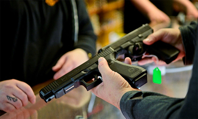A customer compares handguns at a store in Texas. Reuters