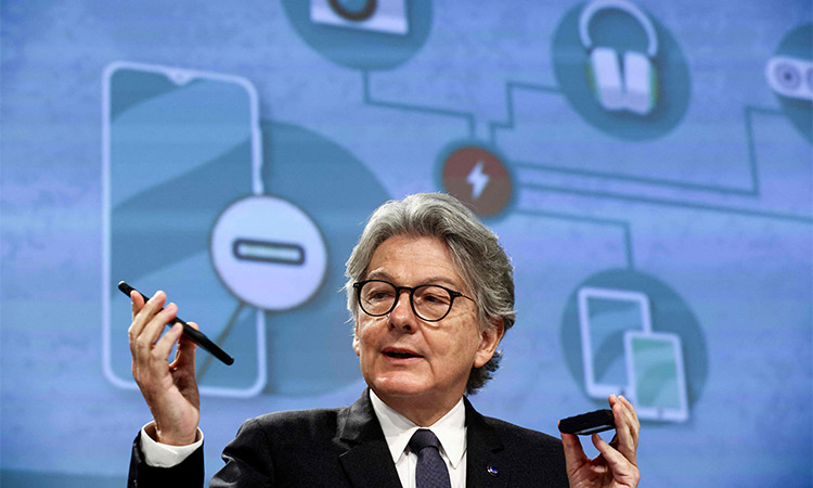 EU commissioner for internal market Thierry Breton shows his mobile phone during a press conference on a common charging solution for electronic devices at the EU headquarters in Brussels. AFP