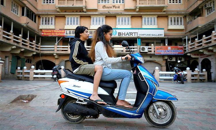 Girls ride an electric scooter in Ahmedabad, India. Reuters