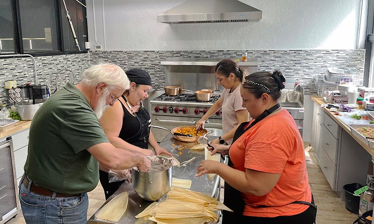 Volunteers at the American Indian Center of Chicago help chef Jessica Pamonicutt, second from left, prepare a contemporary Indigenous meal for seniors. AP