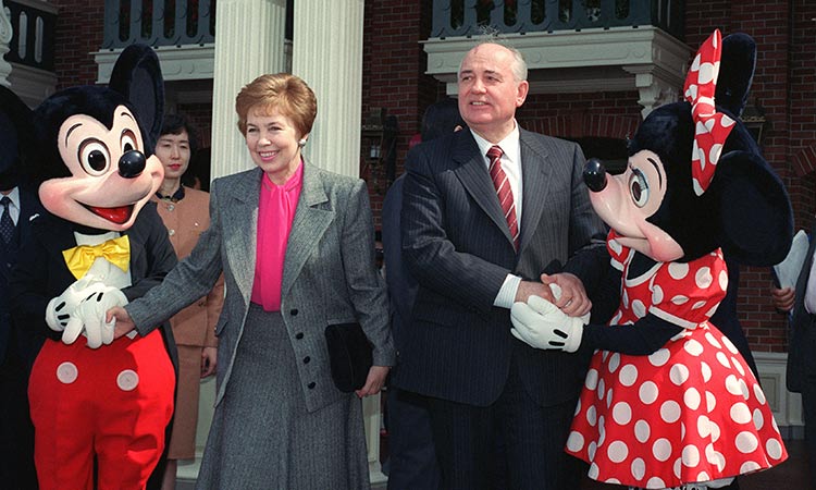 In this photo taken on April 12, 1992, former Soviet President Mikhail Gorbachev (right) and his wife Raisa shake hands with Mickey and Minnie Mouse at the entrance of Tokyo Disneyland.  File/AFP