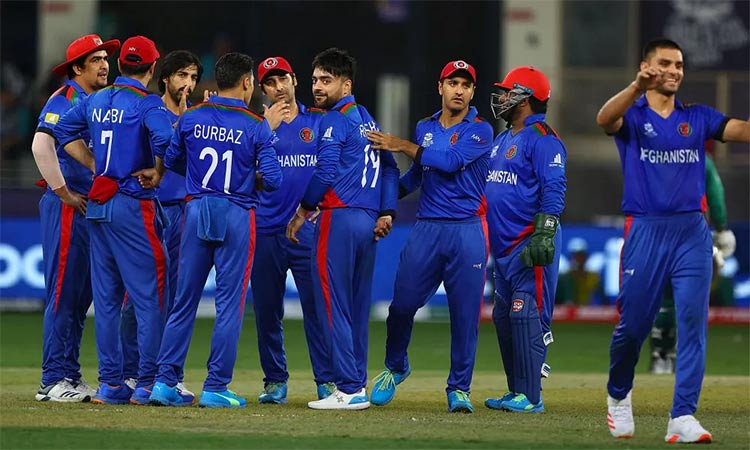 Afghan players gather to celebrate wicket of a Sri Lankan batsman during their match in Dubai.