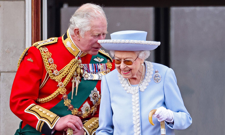 Prince Charles converses with Queen Elizabeth II during the RAF flypast on the balcony of Buckingham Palace during the Trooping the Colour parade in London. File/Tribune News Service
