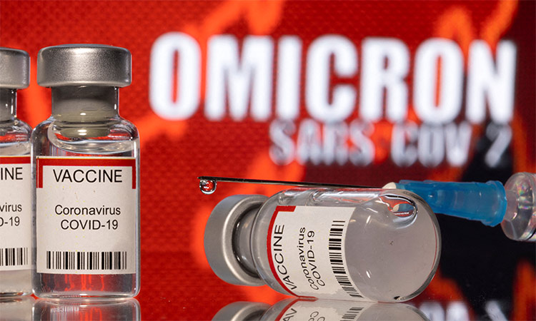 Vials labelled "VACCINE Coronavirus COVID-19"  are seen in front of displayed words "OMICRON SARS-COV-2" in this illustration. Reuters
