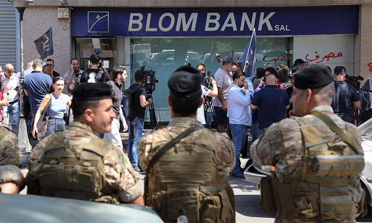 Members of the Lebanese army stand guard outside a Blom Bank branch in Beirut, Lebanon. Reuters
