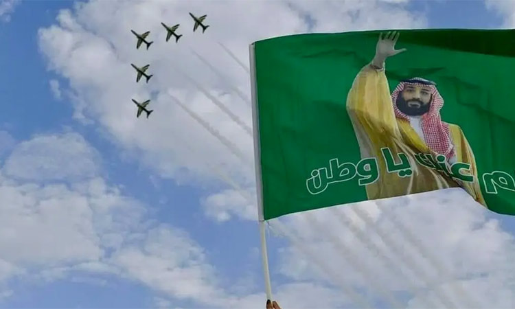 Fighter jets of the Royal Saudi Air Force fly past a flag showing Prince Salman in Riyadh. (Supplied: Twitter)