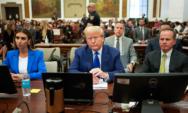 Donald Trump (center), flanked by his defense attorneys, Alina Habba (left), and Chris Kise, waits for the continuation of his civil business fraud trial at New York Supreme Court, in New York. AP