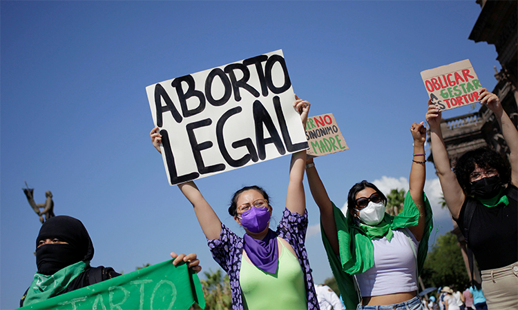 Pro-abortion activists hold up banners reading "Legal abortion" and "Forcing gestation is torture" in Belen, New Mexico. Reuters