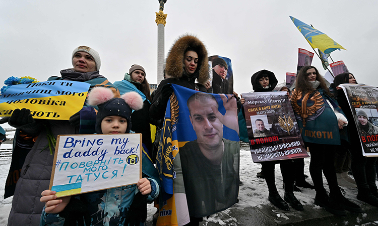 Protesters hold placards during a rally organised by relatives of Ukrainian servicemen held captive by Russian forces to demand their release, at Independence Square in Kyiv.   File/Agence France-Presse