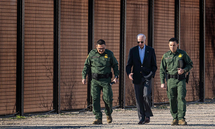 Joe Biden speaks with US Customs and Border Protection officers as he visits the US-Mexico border in El Paso, Texas.  Tribune News Service
