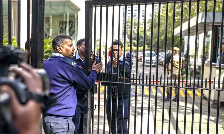Private security guards close the gate of a building housing the BBC office in New Delhi on Tuesday. AP