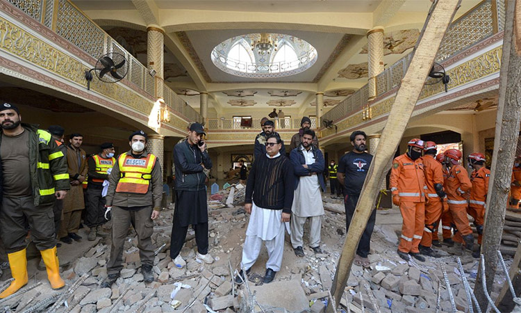 Rescue workers conduct an operation to clear the rubble and search for bodies at the site of the blast. AP