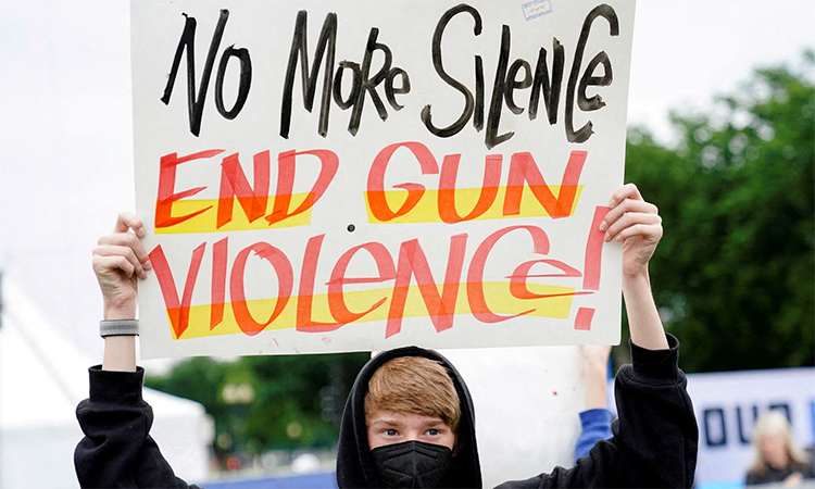  A demonstrator holds a placard while taking part in the 'March for Our Lives', one of a series of nationwide protests against gun violence, in Washington. Reuters