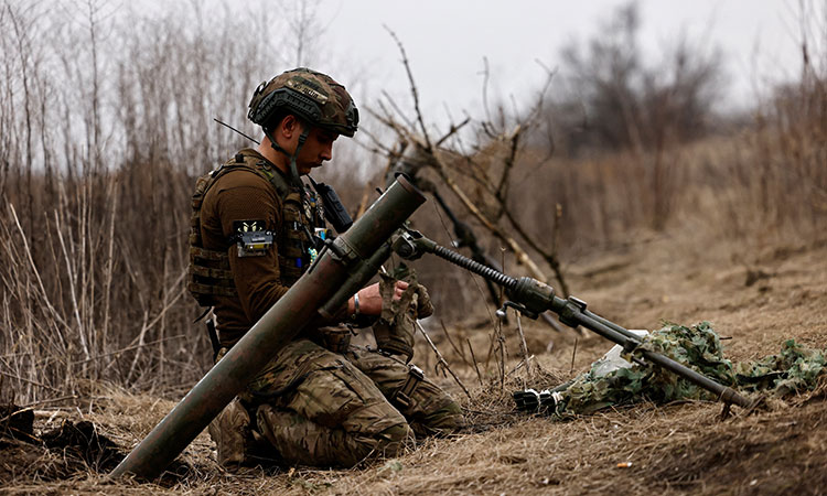 A Ukrainian soldier awaits order to fire a mortar shell at a frontline position near Bakhmut, amid Russia’s attack on Ukraine, in Donetsk region on Thursday. Reuters