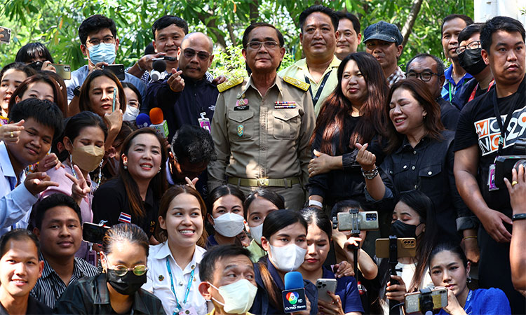 Thailand’s Prime Minister Prayuth Chan-ocha poses with members of media, after Thailand's King Maha Vajiralongkorn has endorsed a decree to dissolve parliament, at the Government House in Bangkok. Reuters