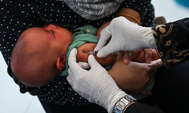 A baby receives the Bacillus Calmette-Guerin (BCG) vaccine for tuberculosis during a national immunisation for children programme at an integrated services post in Banda Aceh, Indonesia.  Tribune News Service