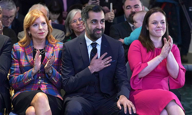 Scottish National Party leader candidates Ash Regan (left), and Kate Forbes applaud as Humza Yousaf, (centre) is announced new SNP leader, at Murrayfield Stadium, in Edinburgh, Scotland, on Monday. AP